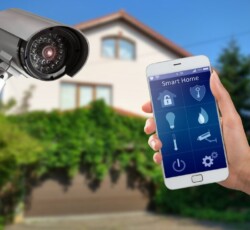 Home 15 smart security systems - view of a person holding a mobile phone